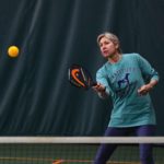 Woman playing pickleball indoors at Guilford Racquet & Swim Club